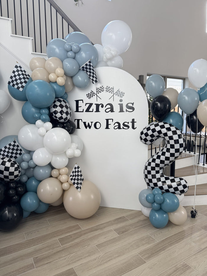 Two Fast race car themed second birthday balloon backdrop with checkered balloons