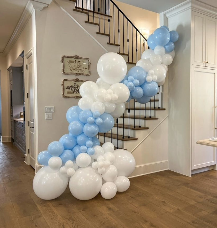 Blue and white balloon garland cascading down a staircase