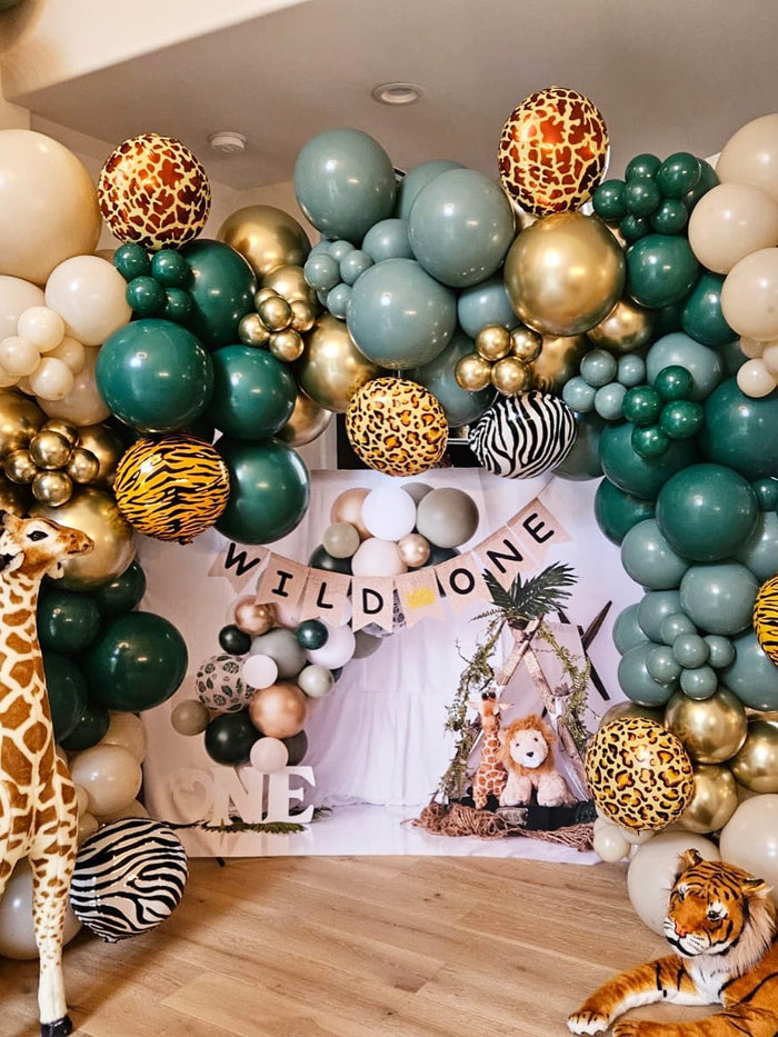 Wild One safari themed balloon garland with animal print balloons for a first birthday