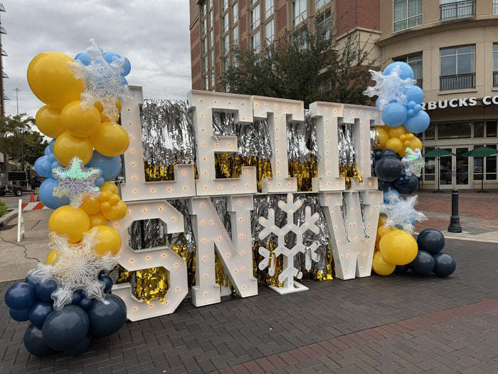 Let It Snow marquee letters with winter balloon garland at Sugar Land Town Square